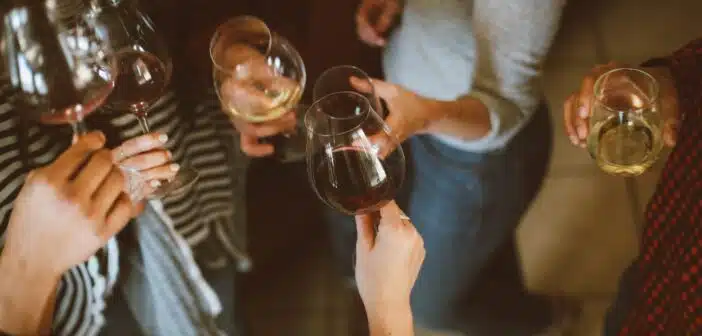 group of people tossing wine glass